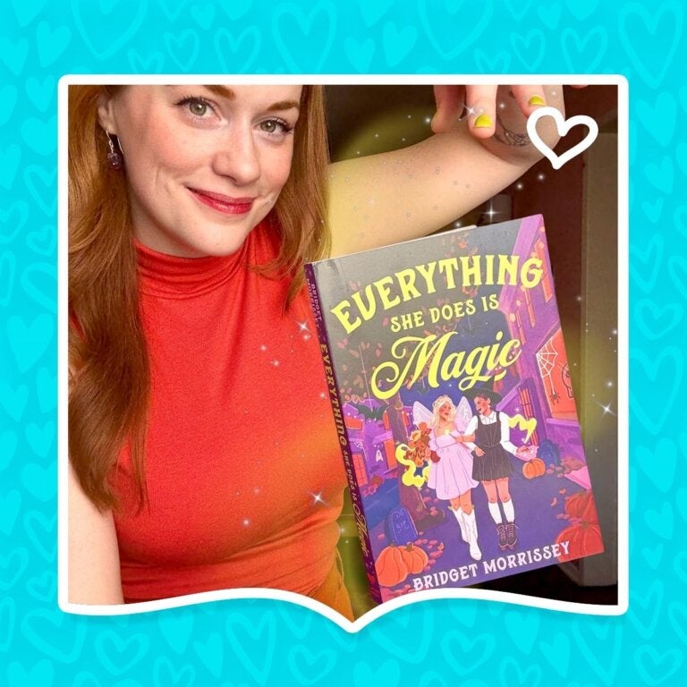 Author Bridget Morrissey pretends to levitate her book Everything She Does Is Magic.