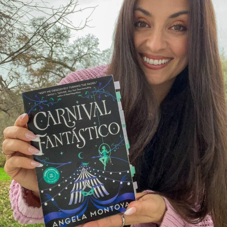 Angela Montoya, author of Carnival Fantástico, poses with her book