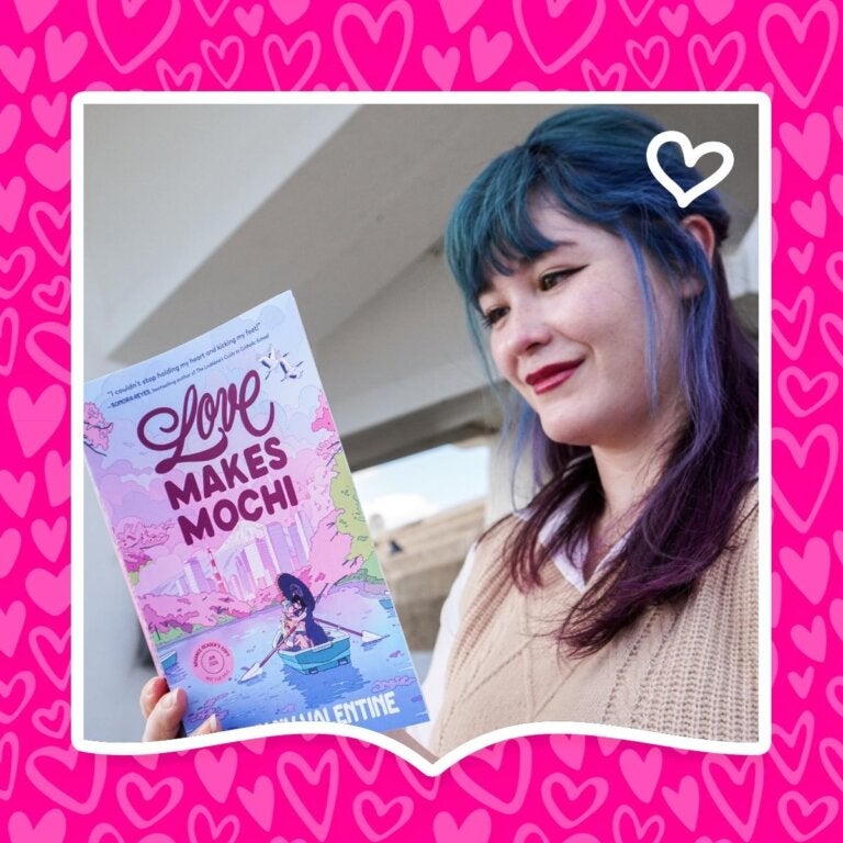 Author Stefany Valentine poses with her YA romance novel Love Makes Mochi